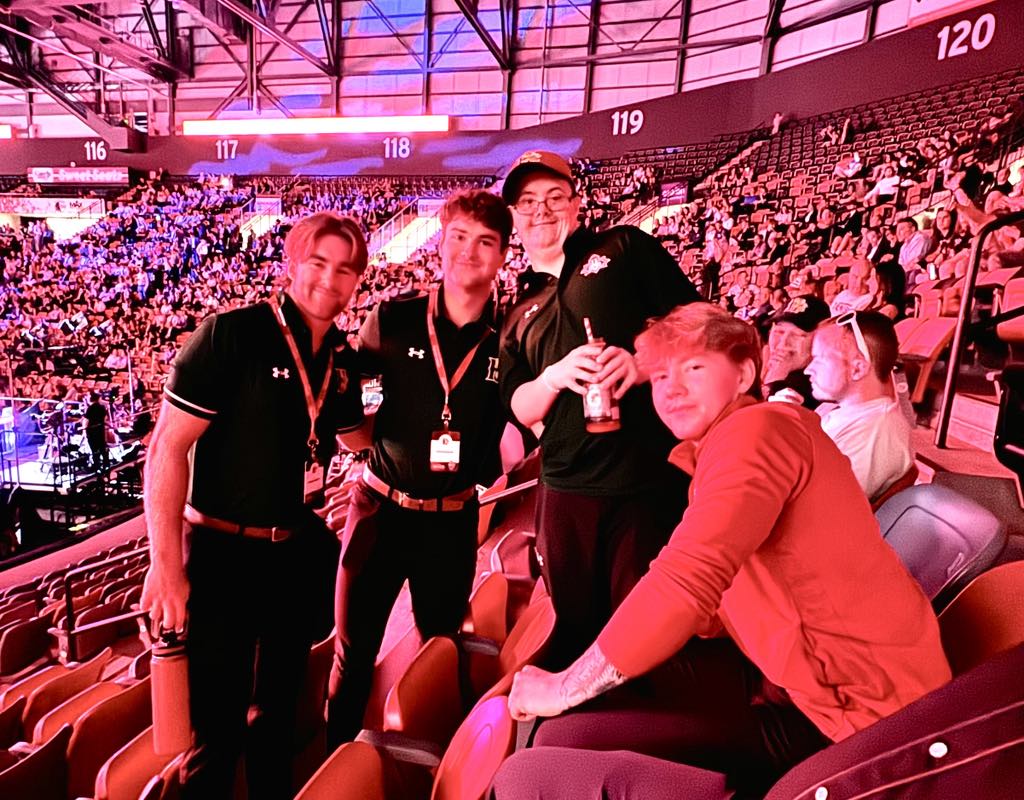 Tyler and hockey staff at the arena