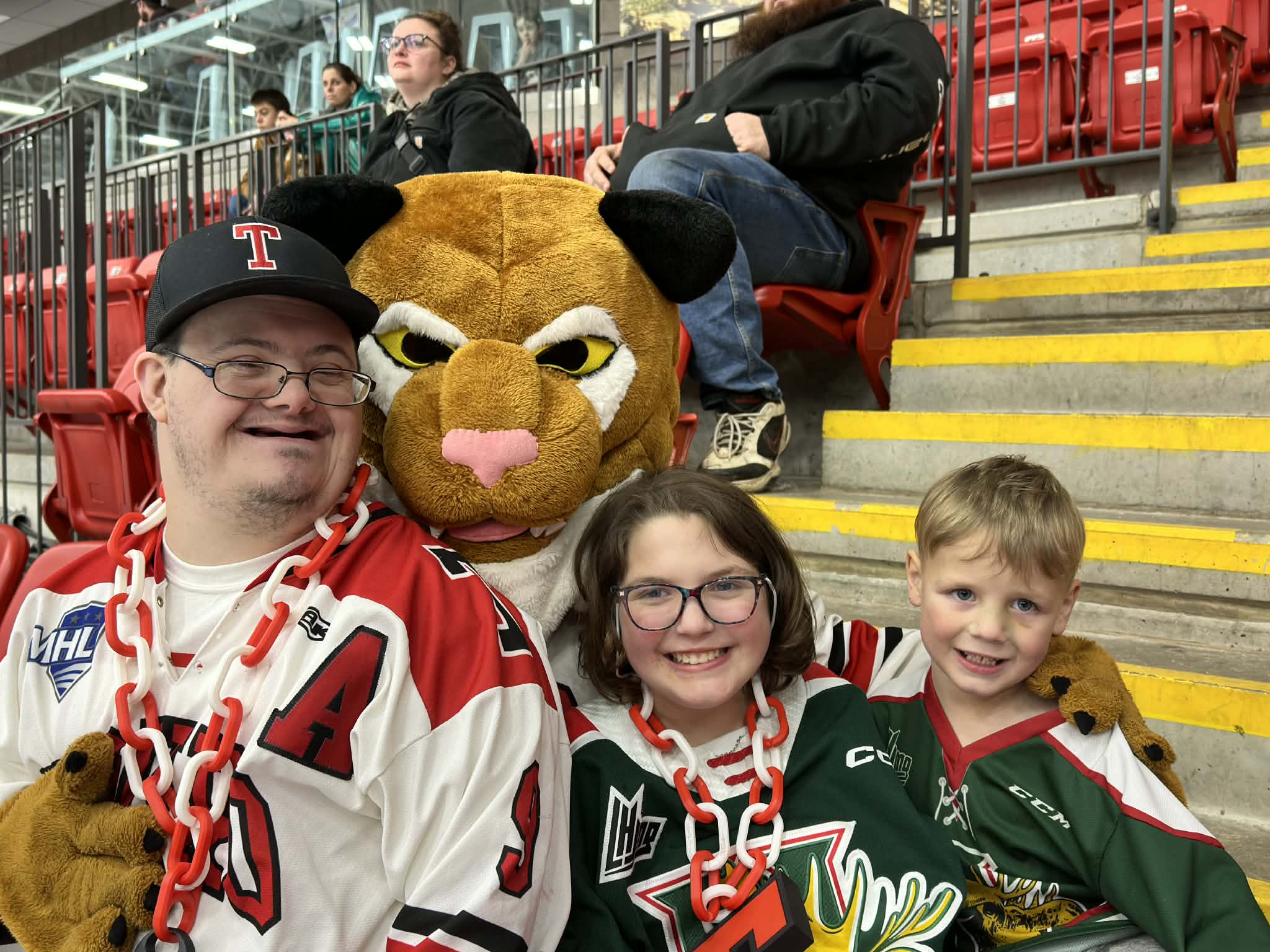 Tyler with young hockey fans and a mascot