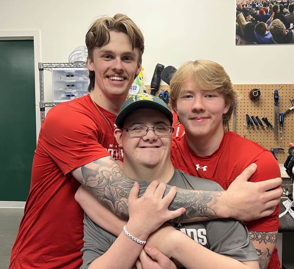 Tyler sharing a joyful moment with hockey friends